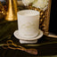 Candle on a table, laying next to wick cutters