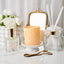 Decorative items including a candle, diffuser, and flowers on a white surface.