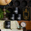 Black candle containers with mountain design on a map with vintage items