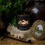 Black Hills Candle on a rustic surface with decorative elements