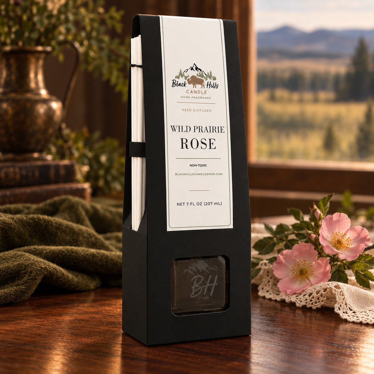 Wild Prairie Rose reed diffuser in black gift packaging in a dark country-chic setting
