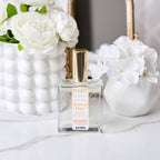 Perfume bottle labeled 'Better Days' with white flowers in the background