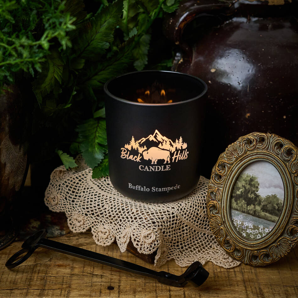 Black Hills Candle on a rustic surface with decorative elements