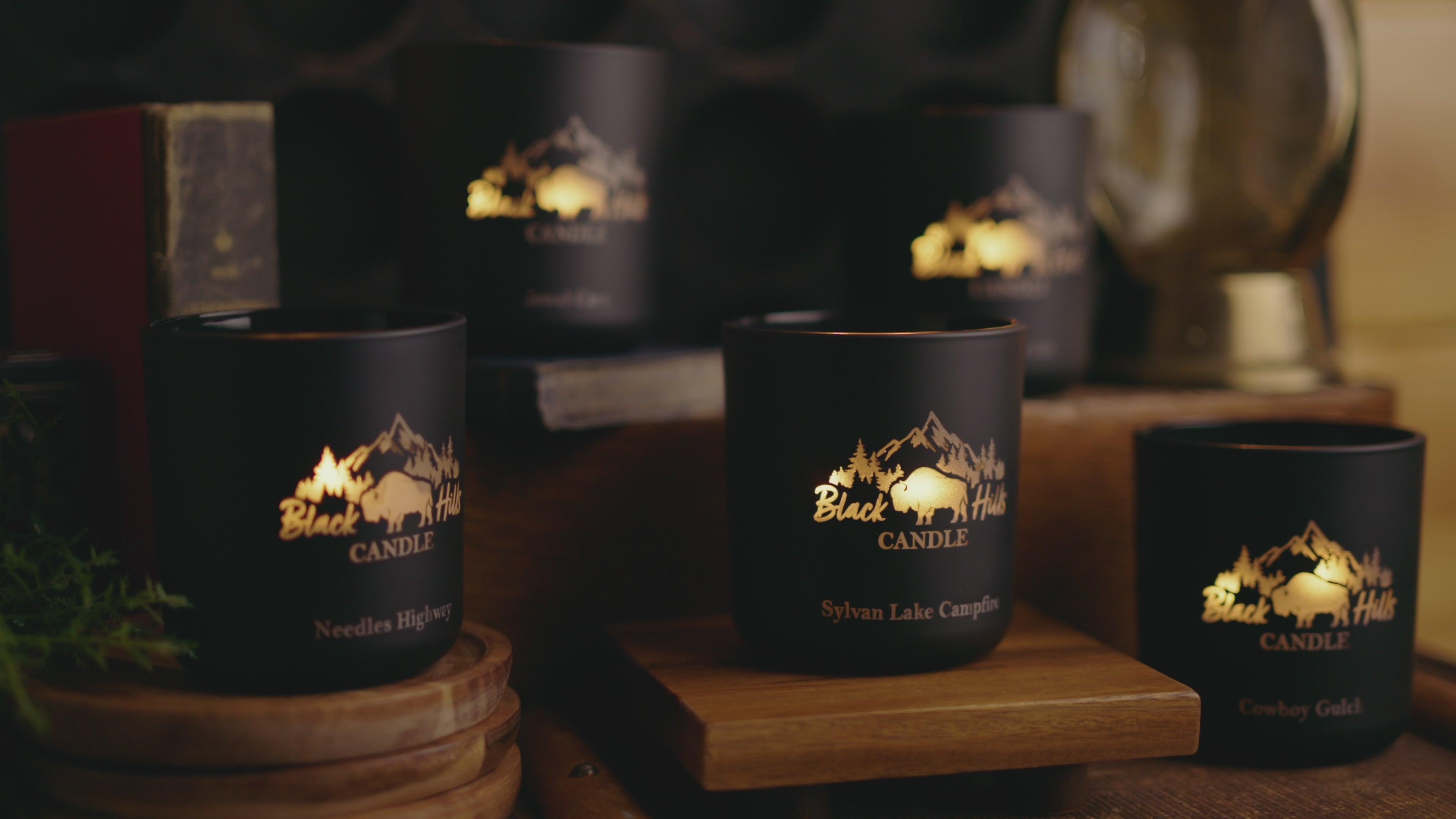 Five black candles flickering on a table. Needles, Highways, Sylvan Lake, Campfire, Cowboy Gulch