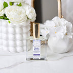 Room perfume bottle labeled 'Quiet Ritual' with white flowers in the background