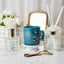 Decorative items including a blue candle, diffuser, and flowers on a white surface.