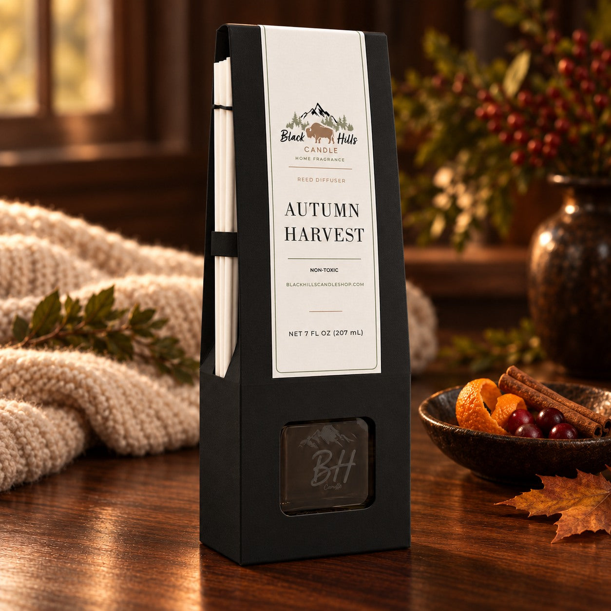 Autumn Harvest reed diffuser in black gift packaging in a dark country-chic setting