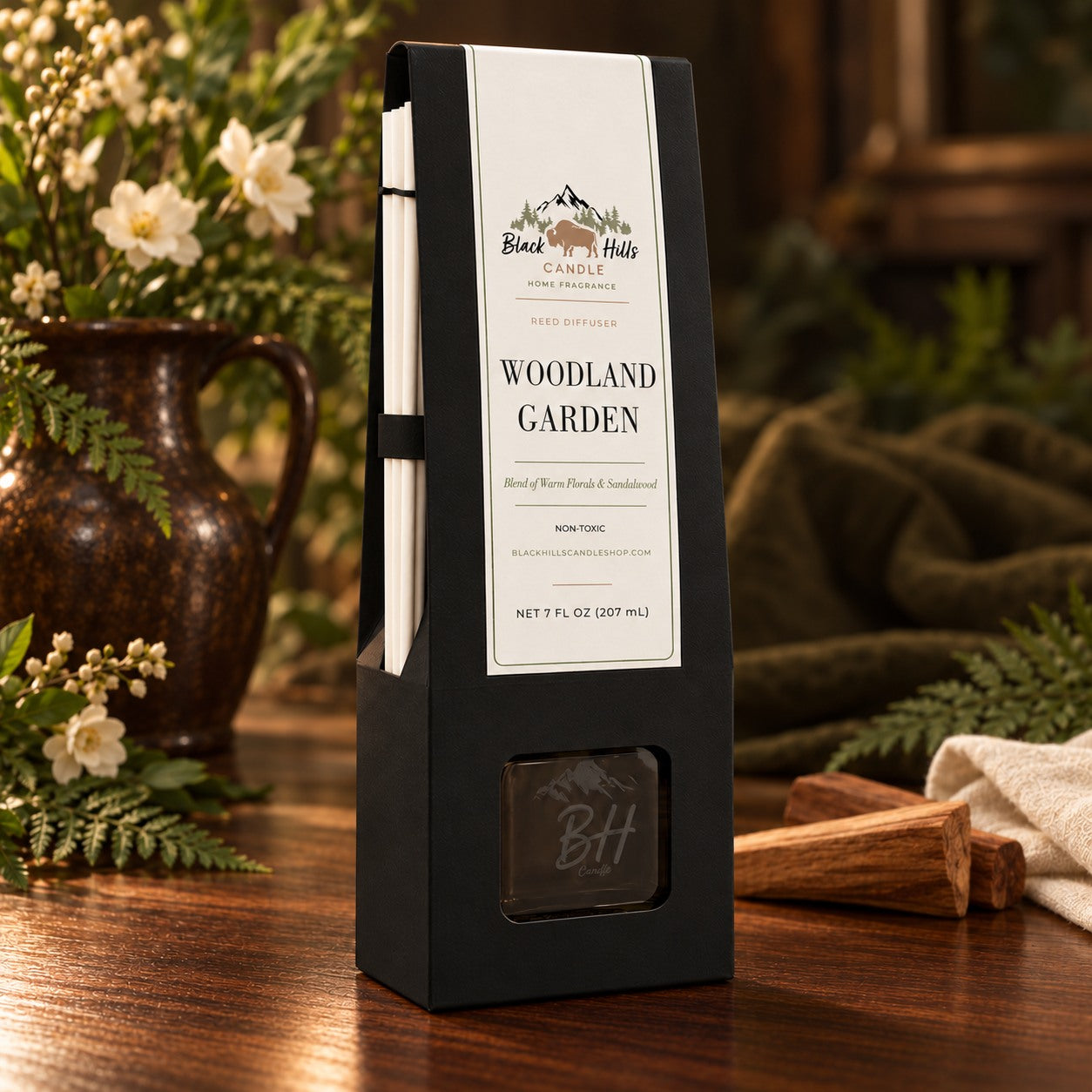 Woodland Garden reed diffuser in black gift packaging in a dark country-chic setting